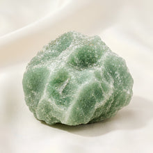 Load image into Gallery viewer, Green Aventurine Raw Stone displayed fully on white silk cloth to show its natural colour, shape and finish
