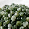 Close-up of authentic natural Green Jade showing crystal texture, colour and craftsmanship – green jade chips stone symbol of prosperity longevity and serenity