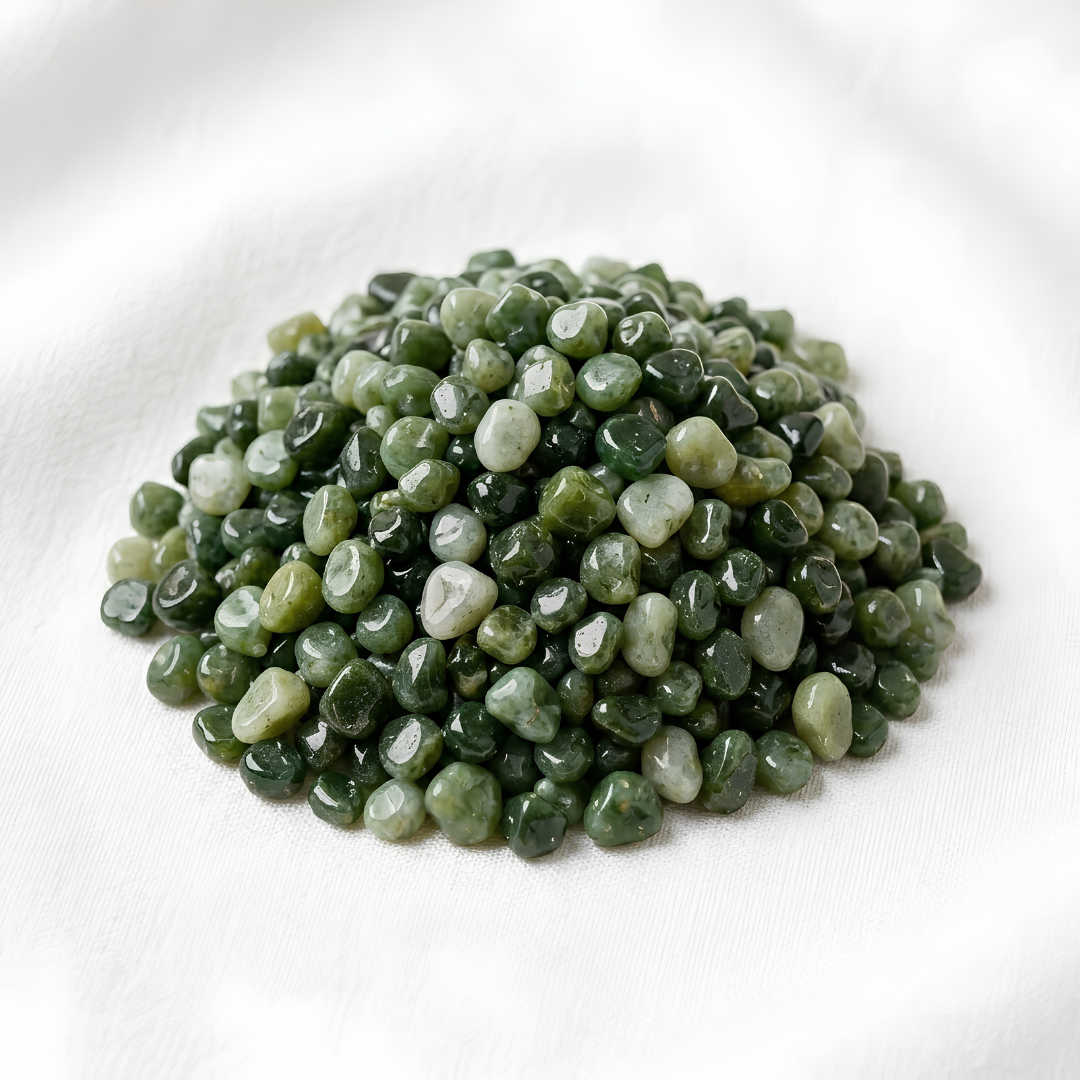 Green Jade Chips displayed fully on white silk cloth to show its natural colour, shape and finish