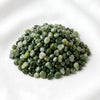 Green Jade Chips displayed fully on white silk cloth to show its natural colour, shape and finish