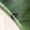 Close-up of authentic natural Green Jade showing crystal texture, colour and craftsmanship – green jade gua sha symbol of prosperity longevity and serenity