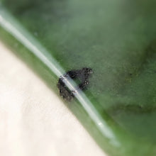 Load image into Gallery viewer, Close-up of authentic natural Green Jade showing crystal texture, colour and craftsmanship – green jade gua sha symbol of prosperity longevity and serenity
