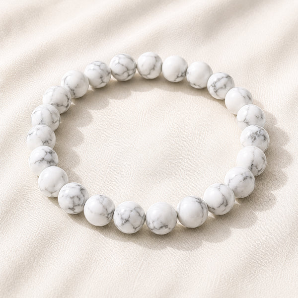 Howlite Bracelet displayed fully on white silk cloth to show its natural colour, shape and finish
