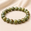 Kiwi Jasper Bracelet displayed fully on white silk cloth to show its natural colour, shape and finish