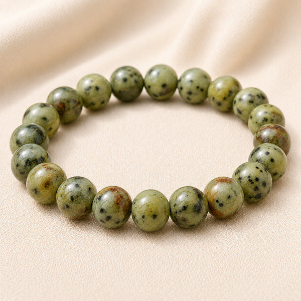 Kiwi Jasper Bracelet displayed fully on white silk cloth to show its natural colour, shape and finish