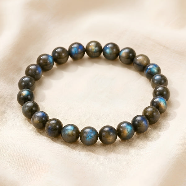 Labradorite Chips displayed fully on white silk cloth to show its natural colour, shape and finish