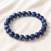 Lapis Lazuli Bracelet displayed fully on white silk cloth to show its natural colour, shape and finish