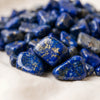 Close-up of authentic natural Lapis Lazuli showing crystal texture, colour and craftsmanship – lapis lazuli chips stone symbol of wisdom truth and royal