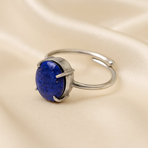 Lapis Lazuli Adjustable Ring displayed fully on white silk cloth to show its natural colour, shape and finish