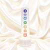 Selenite with 7 Chakra Lamp displayed fully on white silk cloth to show its natural colour, shape and finish
