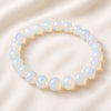 Opal Bracelet displayed fully on white silk cloth to show its natural colour, shape and finish