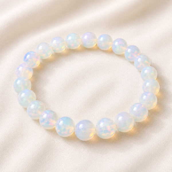 Opal Bracelet displayed fully on white silk cloth to show its natural colour, shape and finish
