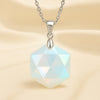 Opal Hexagon Pendant displayed fully on white silk cloth to show its natural colour, shape and finish
