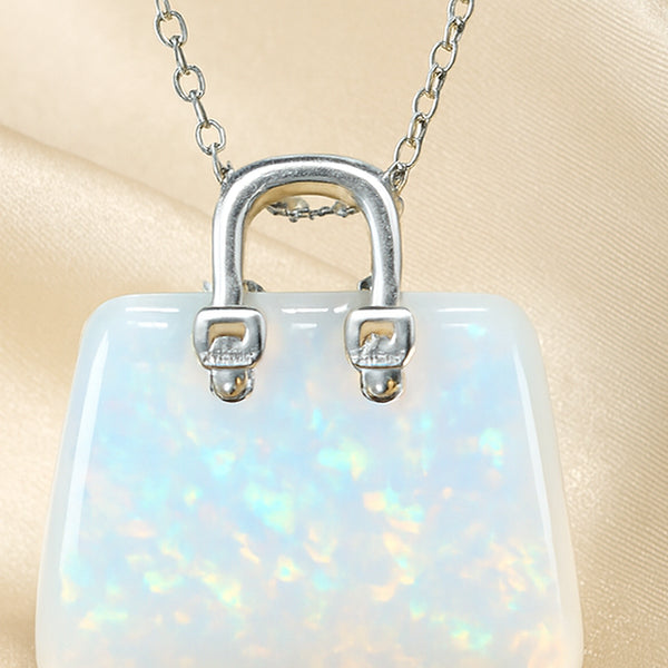 Close-up of authentic natural Opal showing crystal texture, colour and craftsmanship – opal mini handbag pendant symbol of spark hope and luxury