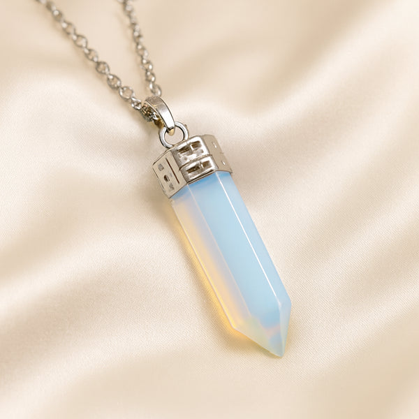 Opalite Pencil Pendant displayed fully on white silk cloth to show its natural colour, shape and finish