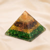 Money Magnet Orgone Pyramid displayed fully on white silk cloth to show its natural colour, shape and finish