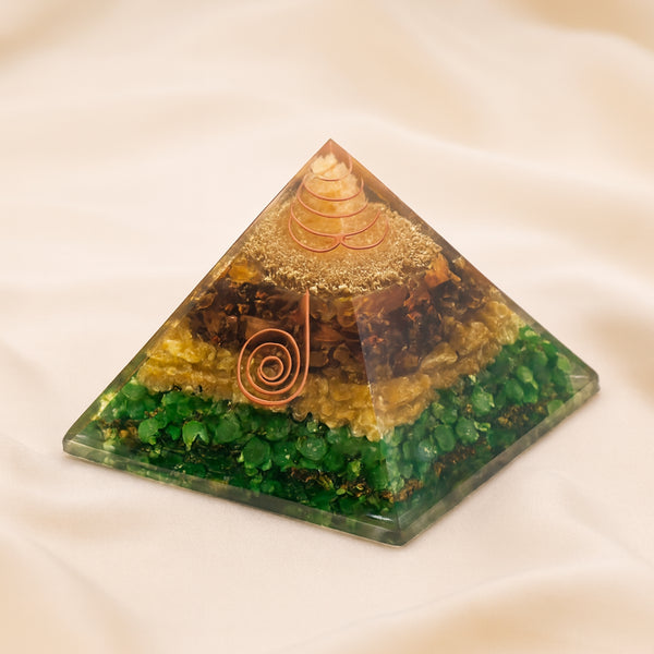 Money Magnet Orgone Pyramid displayed fully on white silk cloth to show its natural colour, shape and finish