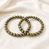 Pyrite Bracelet Pack displayed fully on white silk cloth to show its natural colour, shape and finish – pack of 2 pyrite bracelets wealth protection positivity