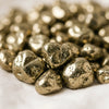 Close-up of authentic natural Pyrite showing crystal texture, colour and craftsmanship – pyrite chips stone symbol of abundance confidence and protection