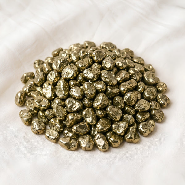 Pyrite Chips displayed fully on white silk cloth to show its natural colour, shape and finish