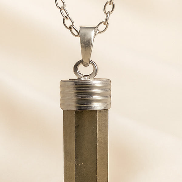 Close-up of authentic natural Pyrite showing crystal texture, colour and craftsmanship – pyrite pencil pendant symbol of abundance confidence and protection