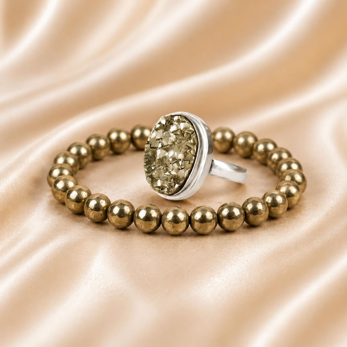 Pyrite Ring & Bracelet Set displayed fully on white silk cloth to show its natural colour, shape and finish