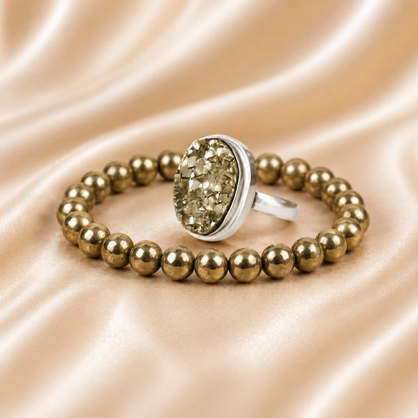 Pyrite Ring & Bracelet Set displayed fully on white silk cloth to show its natural colour, shape and finish