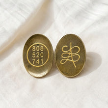 Load image into Gallery viewer, Pyrite Zibu Coin displayed fully on white silk cloth to show its natural colour, shape and finish
