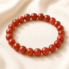 Red Aventurine Bracelet displayed fully on white silk cloth to show its natural colour, shape and finish