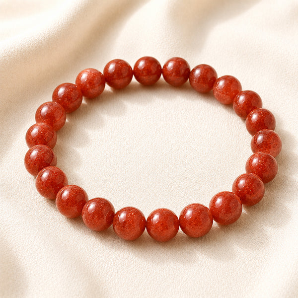 Red Aventurine Bracelet displayed fully on white silk cloth to show its natural colour, shape and finish