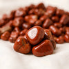 Close-up of authentic natural Red Jasper showing crystal texture, colour and craftsmanship – red jasper chips stone symbol of strength stability and grounding