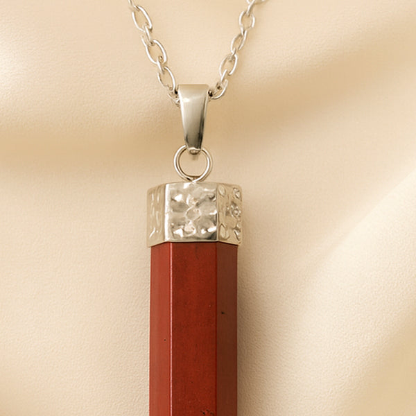 Close-up of authentic natural Red Jasper showing crystal texture, colour and craftsmanship – red jasper pencil pendant symbol of strength stability and