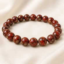 Load image into Gallery viewer, Red Picasso Jasper Bracelet displayed fully on white silk cloth to show its natural colour, shape and finish
