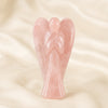 Rose Quartz Angel Figurine displayed fully on white silk cloth to show its natural colour, shape and finish