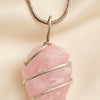 Close-up of authentic natural Rose Quartz showing crystal texture, colour and craftsmanship – rose quartz arrowhead pendant symbol of love compassion and