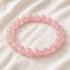 Rose Quartz Bracelet displayed fully on white silk cloth to show its natural colour, shape and finish