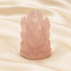 Rose Quartz Ganesh Idol displayed fully on white silk cloth to show its natural colour, shape and finish