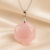 Rose Quartz Hexagon Pendant displayed fully on white silk cloth to show its natural colour, shape and finish