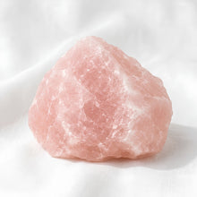 Load image into Gallery viewer, Rose Quartz Raw Stone displayed fully on white silk cloth to show its natural colour, shape and finish
