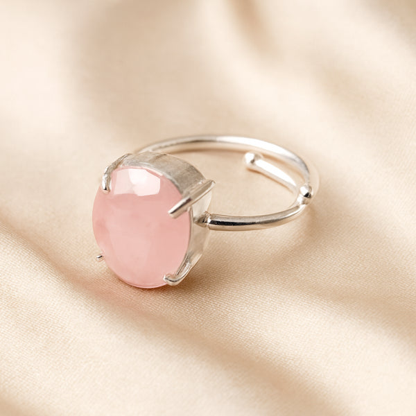 Rose Quartz Adjustable Ring displayed fully on white silk cloth to show its natural colour, shape and finish