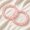 Rose Quartz Bracelet Set displayed fully on white silk cloth to show its natural colour, shape and finish