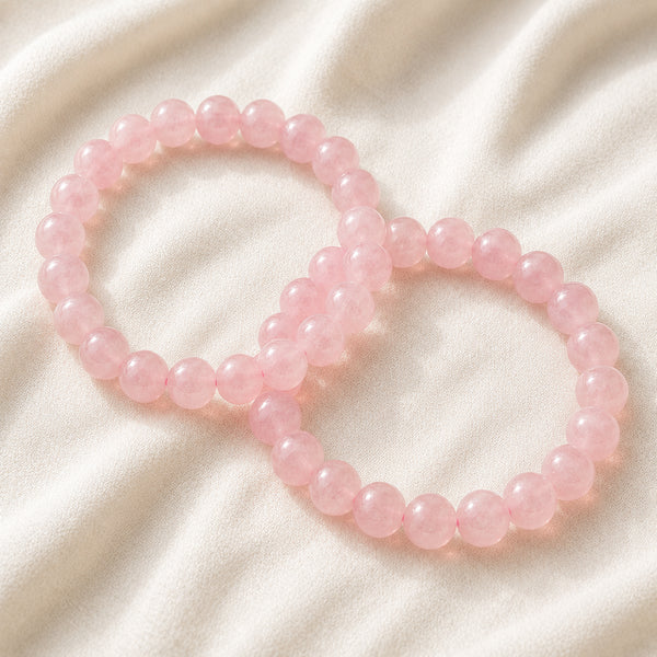 Rose Quartz Bracelet Set displayed fully on white silk cloth to show its natural colour, shape and finish