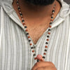 Close-up of authentic natural Rudraksha and Karungali showing crystal texture, colour and craftsmanship