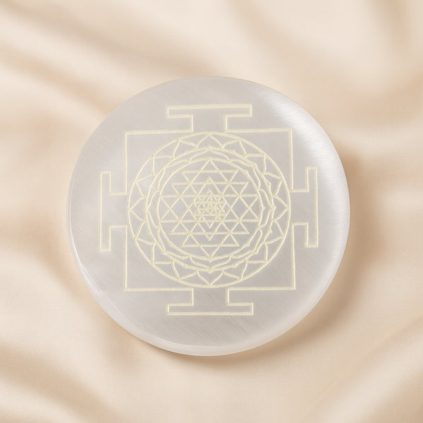 Selenite Sri Yantra Charging Plate displayed fully on white silk cloth to show its natural colour, shape and finish – selenite charging plate sri yantra