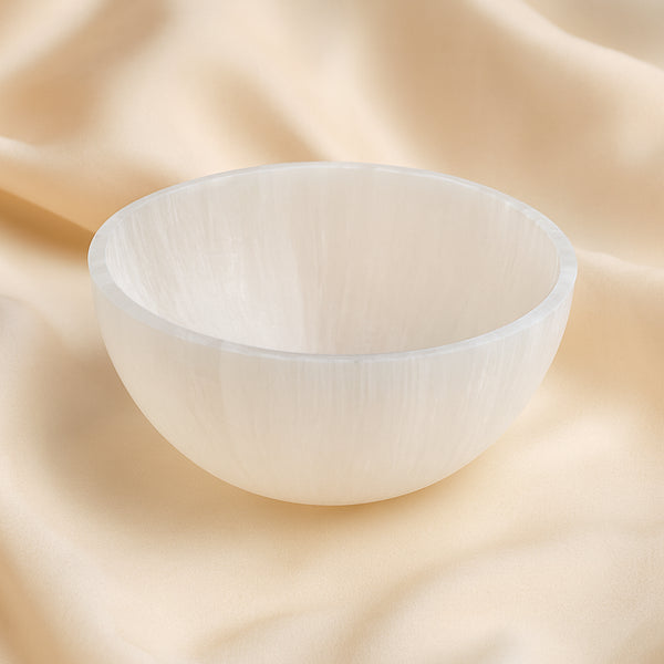Selenite Bowl displayed fully on white silk cloth to show its natural colour, shape and finish