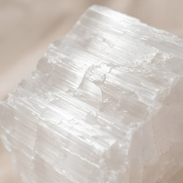 Close-up of authentic natural Selenite showing crystal texture, colour and craftsmanship – selenite raw stone symbol of purity clarity and high vibration