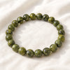 Serpentine Bracelet displayed fully on white silk cloth to show its natural colour, shape and finish