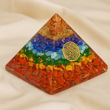 Load image into Gallery viewer, 7 Chakra Orgone Pyramid displayed fully on white silk cloth to show its natural colour, shape and finish
