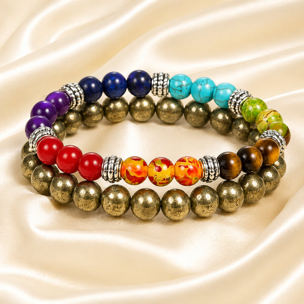 7 Chakra & Pyrite Bracelet Set displayed fully on white silk cloth to show its natural colour, shape and finish