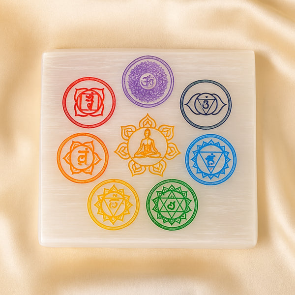 Square Selenite 7 Chakra Charging Plate displayed fully on white silk cloth to show its natural colour, shape and finish